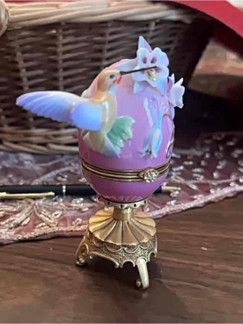 Franklin Mint House of Fabergé hummingbird egg trinket box on a golden stand.